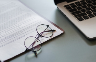 Glasses and a laptop on a desk