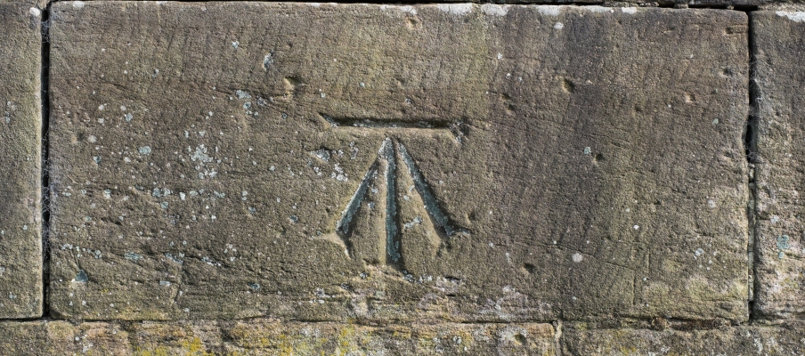 Ordnance Survey benchmark on stone wall
